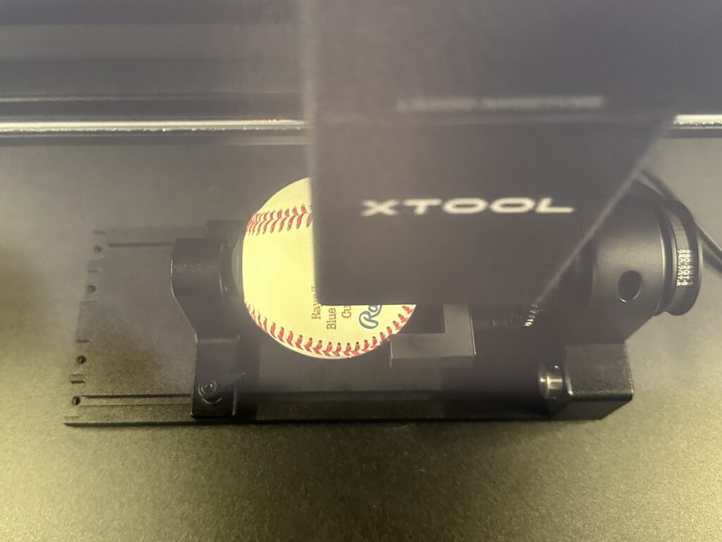 In process shot of engraving a baseball with the xTool P2 - cuttingforbusiness.com